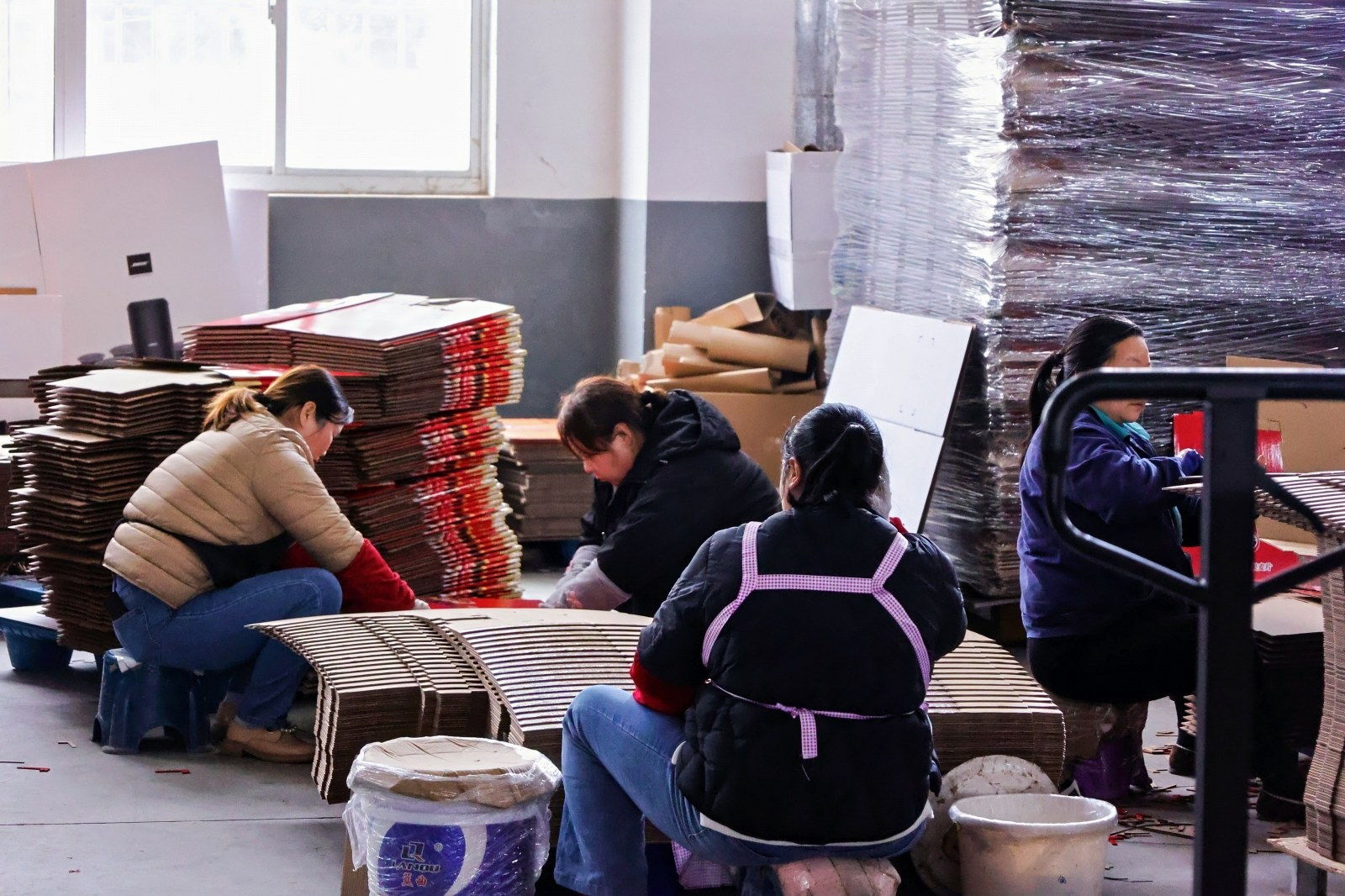 Workers hand assembling packaging