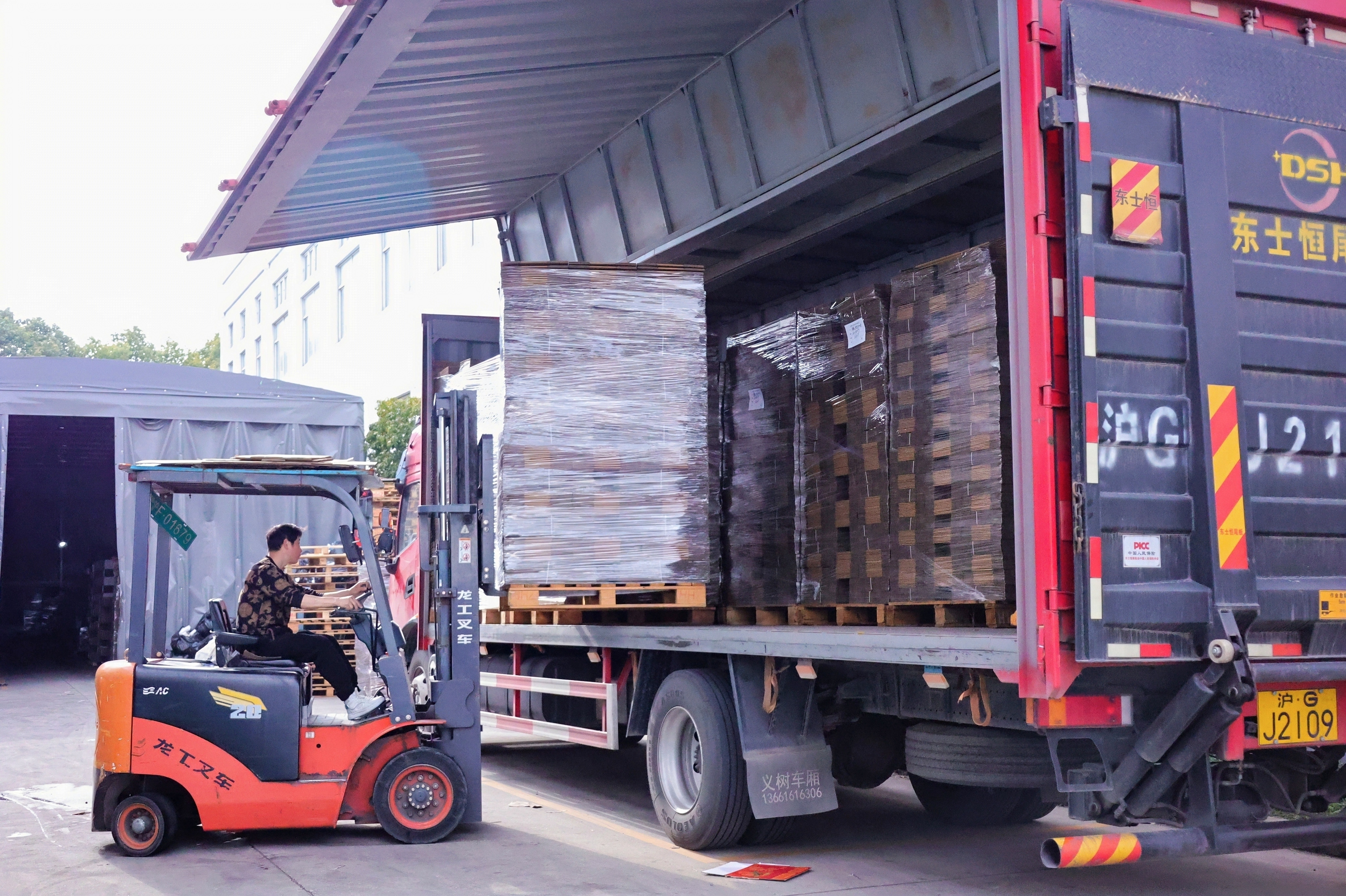 Forklift loading pallets onto truck